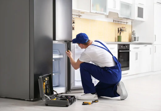 Repair specialist inspecting a refrigerator in a bright kitchen